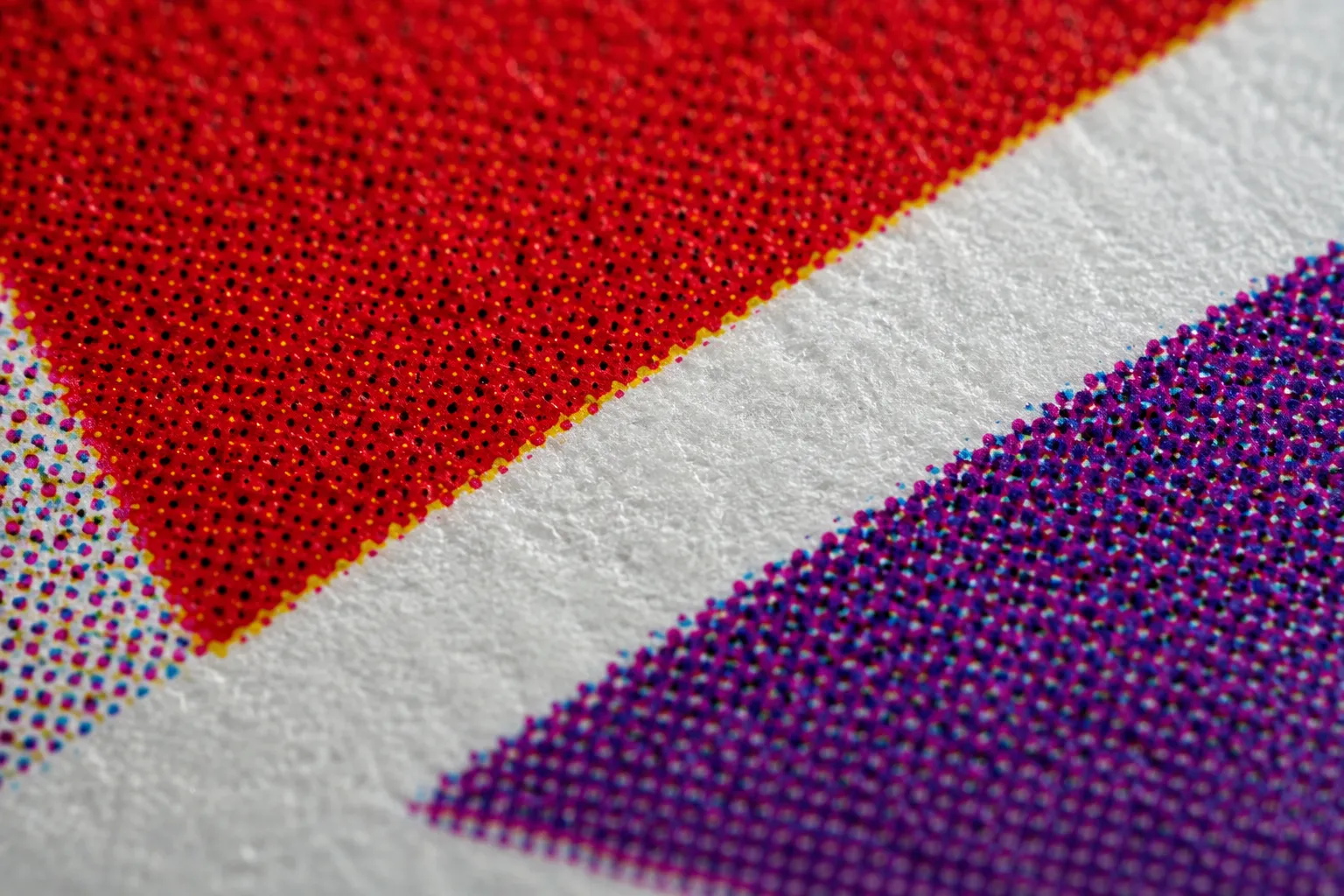 Macro extrême de points de trame rouge et violet sur un support d'étiquette imprimé